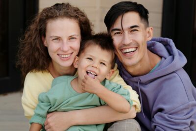 A smiling diverse family representing happy clients who have successfully found homes in the Wilmington area through the help of Marie Howard-Griffin.